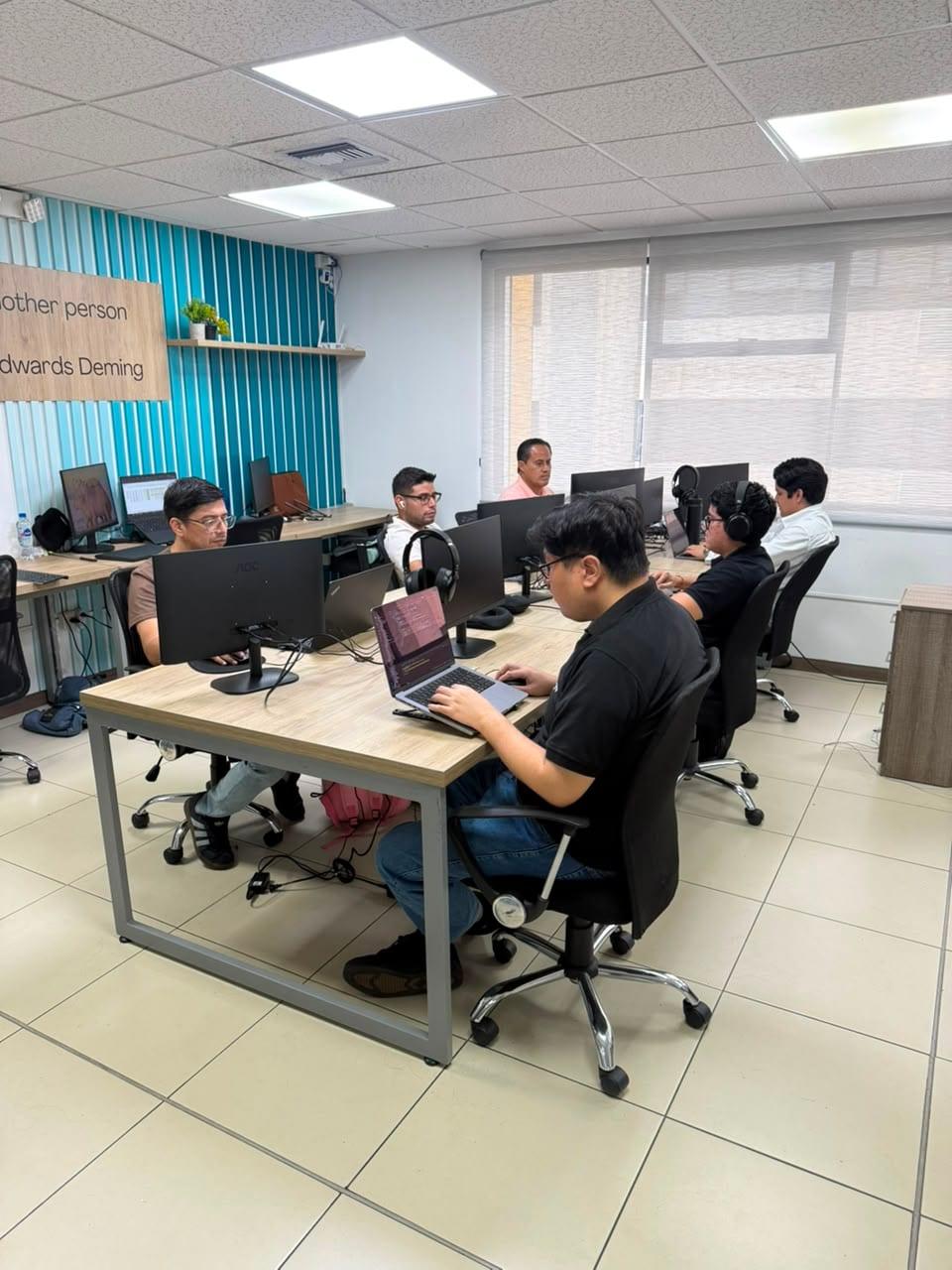 DataPoint teammates collaborating around a laptop