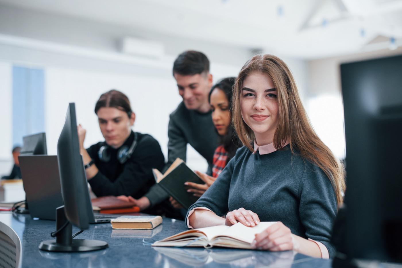 Young people studying and collaborating in a modern classroom