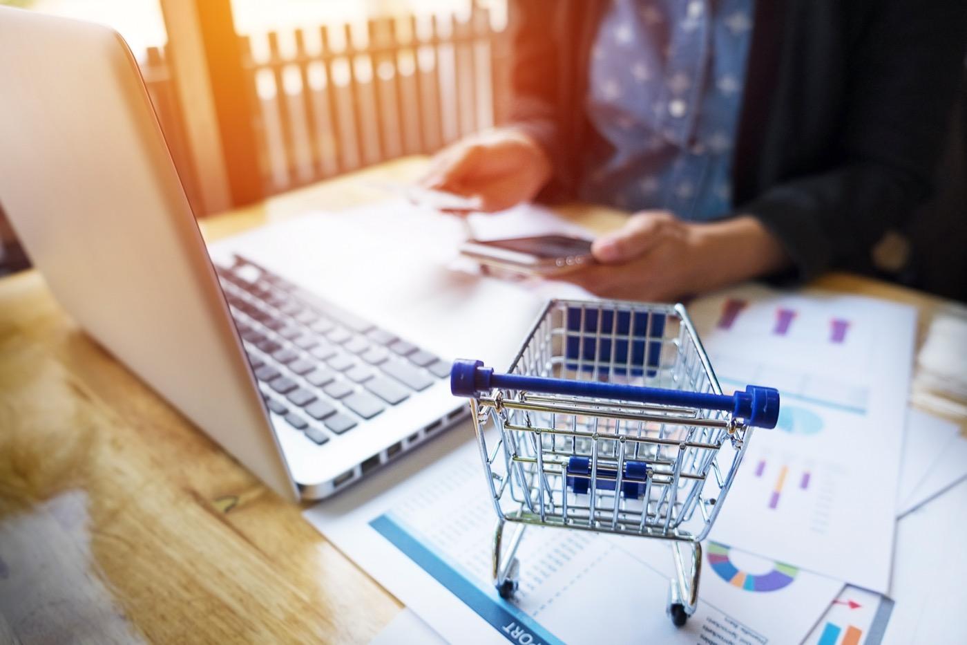 Online shopping setup with shopping cart and analytics charts