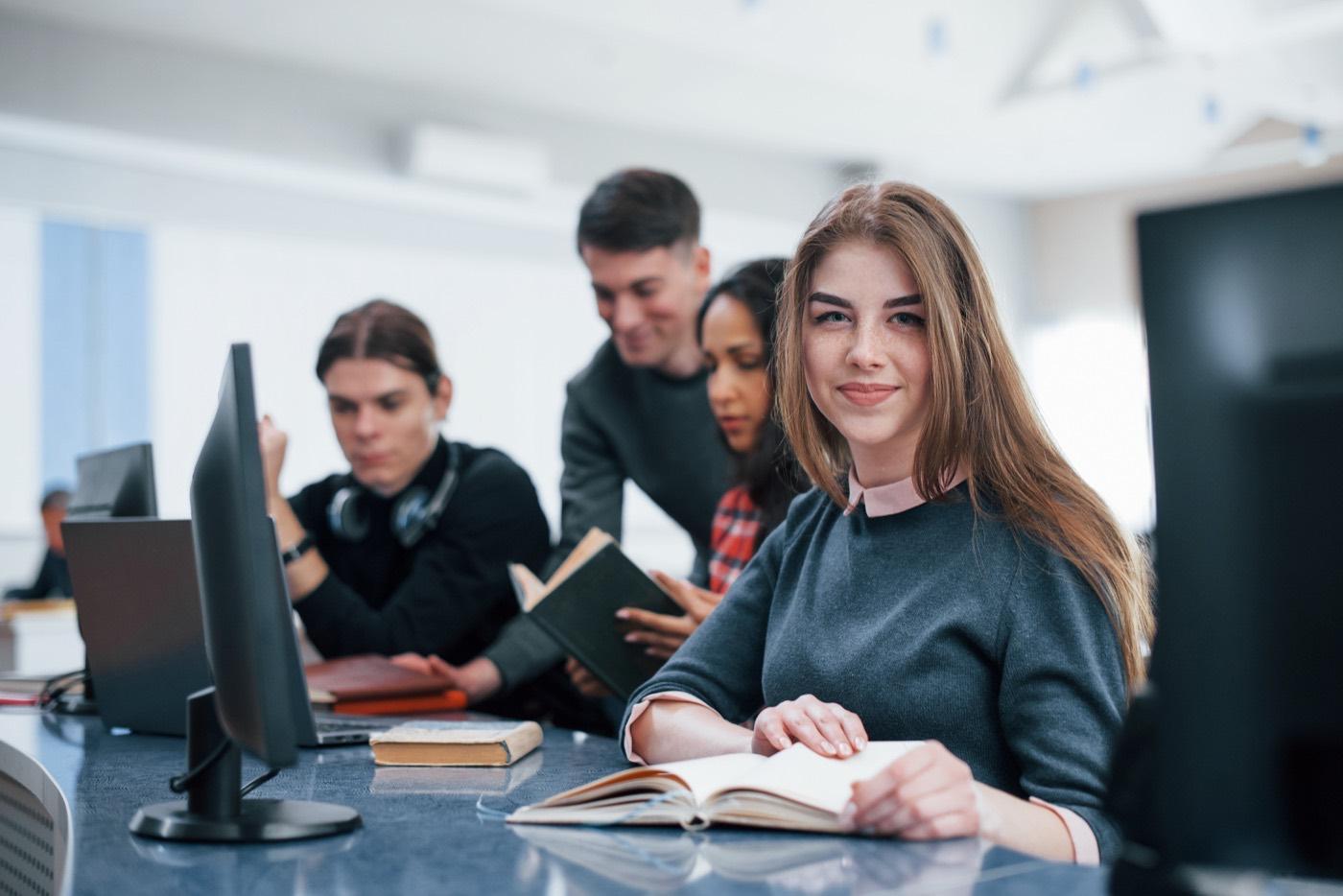 Young people studying and collaborating in a modern classroom